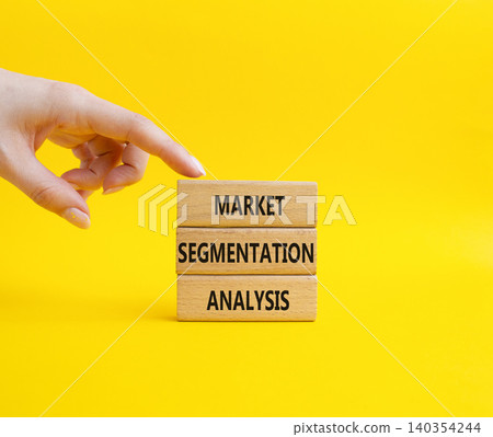Market Segmentation Analysis symbol. Concept word Market Segmentation Analysis on wooden blocks. Businessman hand. Beautiful yellow background. Business and Market Segmentation Analysis. Copy space 140354244