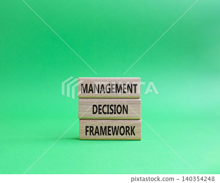 Management Decision Framework symbol. Concept word Management Decision Framework on wooden blocks. Beautiful green background. Business and Management Decision Framework. Copy space Management Decision Framework symbol. Concept word Management Decision Framework on wooden blocks. Beautiful green background. Business and Management Decision Framework. Copy space 140354248