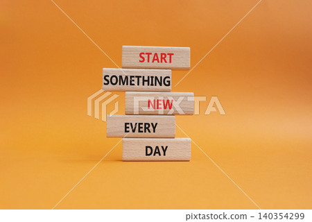 New symbol. Wooden blocks with words Start Something New Every Day. Beautiful orange background. Business and New concept. Copy space 140354299