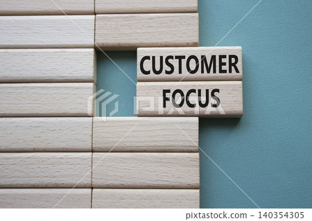 CUSTOMER FOCUS symbol. Concept word CUSTOMER FOCUS on wooden blocks. Beautiful grey green background. Business and CUSTOMER FOCUS concept. Copy space CUSTOMER FOCUS symbol. Concept word CUSTOMER FOCUS on wooden blocks. Beautiful grey green background. Business and CUSTOMER FOCUS concept. Copy space 140354305