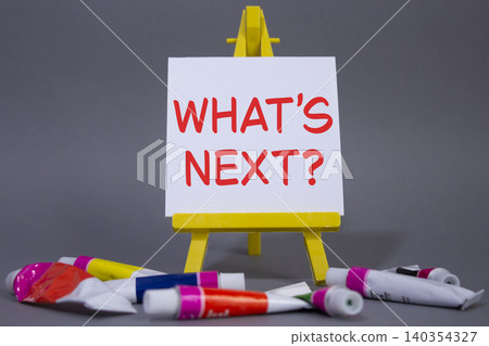 What is next symbol. Concept words What is next on wooden blocks. Beautiful grey background with paints and easel. Business and What is next concept. Copy space. What is next symbol. Concept words What is next on wooden blocks. Beautiful grey background with paints and easel. Business and What is next concept. Copy space. 140354327