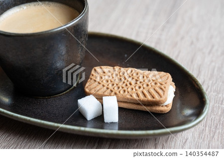 Coffee with biscuit and sugar cubes Coffee with biscuit and sugar cubes 140354487