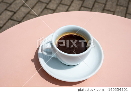 Cup of coffee on pink table Cup of coffee on pink table 140354501