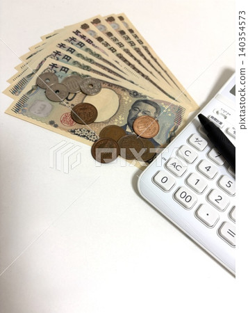Japanese new banknotes, coins, and a calculator spread out in a fan shape. Japanese new banknotes, coins, and a calculator spread out in a fan shape. 140354573