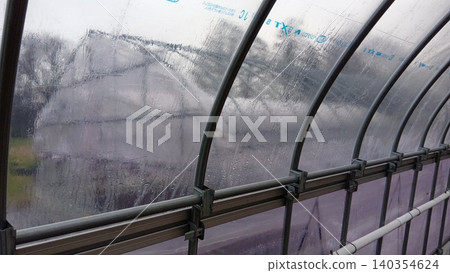 A greenhouse with plastic sheeting blown away A greenhouse with plastic sheeting blown away 140354624