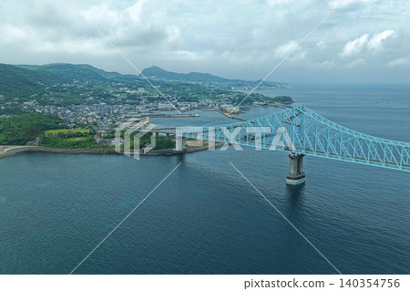 An aerial photograph overlooking the Ikitsuki Bridge and Tateura Fishing Port in Hirado City, Nagasaki Prefecture. An aerial photograph overlooking the Ikitsuki Bridge and Tateura Fishing Port in Hirado City, Nagasaki Prefecture. 140354756