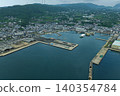 An aerial photograph overlooking Tateura Fishing Port and the fishing village on Ikitsuki Island in Hirado City, Nagasaki Prefecture. 140354784