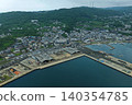 An aerial photograph overlooking Tateura Fishing Port and fishing village on Ikitsuki Island in Hirado City, Nagasaki Prefecture. 140354785