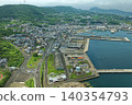 An aerial photograph overlooking Tateura Fishing Port and fishing village on Ikitsuki Island in Hirado City, Nagasaki Prefecture. 140354793