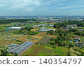 An aerial photograph overlooking farmland and greenhouses in the suburbs of Fujisawa City, Kanagawa Prefecture. 140354797