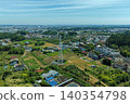 An aerial photograph overlooking a suburban residential area, farmland, and transmission towers in Fujisawa City, Kanagawa Prefecture. 140354798