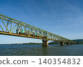 A local train running across the Yoshinogawa Bridge between Sako Station and Yoshinari Station on the Kotoku Line in Tokushima Prefecture. 140354832