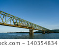 A local train running across the Yoshinogawa Bridge between Sako Station and Yoshinari Station on the Kotoku Line in Tokushima Prefecture. 140354834