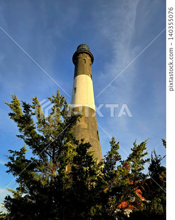 Historic Lighthouse Against a Clear Blue Sky Historic Lighthouse Against a Clear Blue Sky 140355076