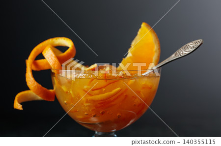 Orange dessert in a glass bowl garnished with orange peel. Orange dessert in a glass bowl garnished with orange peel. 140355115