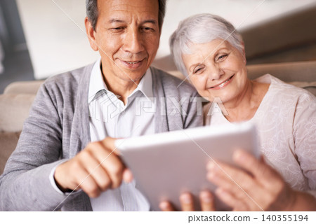 Senior, couple and smile with tablet on sofa for online bingo, crossword puzzle and internet games in living room. Elderly, man and woman with face and happiness with technology for web news in home Senior, couple and smile with tablet on sofa for online bingo, crossword puzzle and internet games in living room. Elderly, man and woman with face and happiness with technology for web news in home 140355194