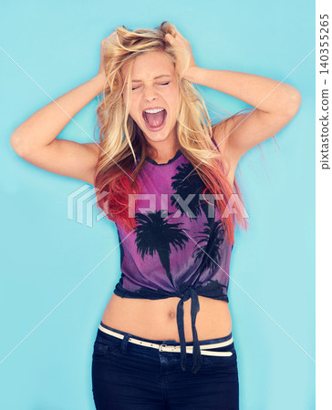 Woman, stress and pull hair in studio, burnout and mental health for fail on blue background. Female person, frustration and screaming in anger for mistake, yelling and anxiety or shouting for rage Woman, stress and pull hair in studio, burnout and mental health for fail on blue background. Female person, frustration and screaming in anger for mistake, yelling and anxiety or shouting for rage 140355265