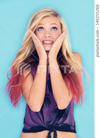 Young woman, thinking and wish in studio mock up in punk fashion and expression in rock style. California, blonde model and idea in trendy clothes and planning in gen z aesthetic by blue background 140355268