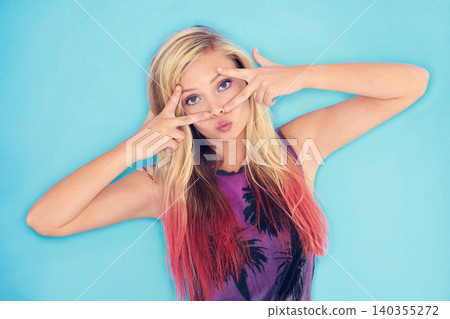 Woman, portrait and rock style in studio mock up and peace gesture for punk attitude for culture. California, model and face with cool eyes in trendy clothes and gen z aesthetic by blue background 140355272