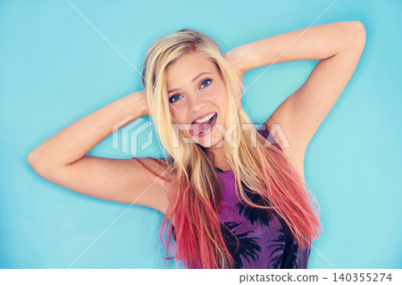 Portrait, blue background and crazy gen z girl with smile in studio, unique and punk with outfit. Youth, fun and female person with funny face, relax and cool with clothes for fashion in summer Portrait, blue background and crazy gen z girl with smile in studio, unique and punk with outfit. Youth, fun and female person with funny face, relax and cool with clothes for fashion in summer 140355274