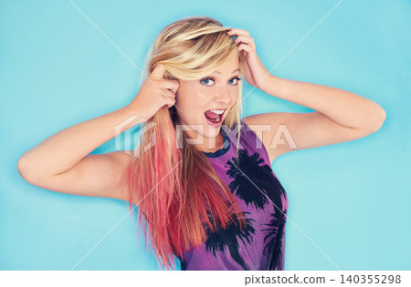 Woman, attitude portrait and punk fashion in studio mock up and surprise emoji in rock style. California, girl and face of celebrating in trendy clothes and pink hair for gen z by blue background Woman, attitude portrait and punk fashion in studio mock up and surprise emoji in rock style. California, girl and face of celebrating in trendy clothes and pink hair for gen z by blue background 140355298