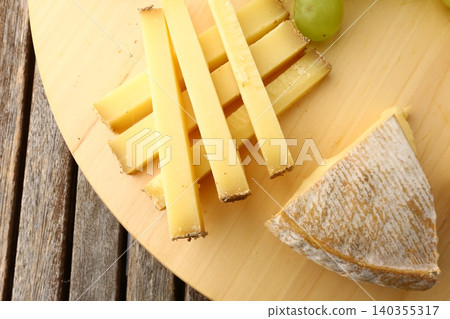 Gourmet Cheese Board with Grapes Morbier Moine and Gruyere Gourmet Cheese Board with Grapes Morbier Moine and Gruyere 140355317