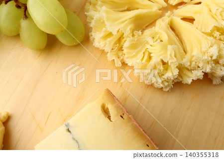 Gourmet Cheese Board with Grapes Morbier Moine and Gruyere Gourmet Cheese Board with Grapes Morbier Moine and Gruyere 140355318