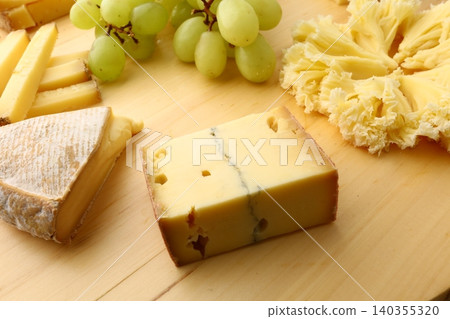 Gourmet Cheese Board with Grapes Morbier Moine and Gruyere Gourmet Cheese Board with Grapes Morbier Moine and Gruyere 140355320