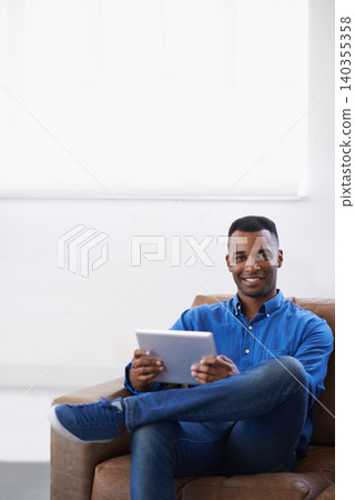 Man, tablet and online in portrait at home, subscribe and internet for website or blog. Black male person, smile and streaming entertainment on couch, mockup space and app for shopping on weekend 140355358
