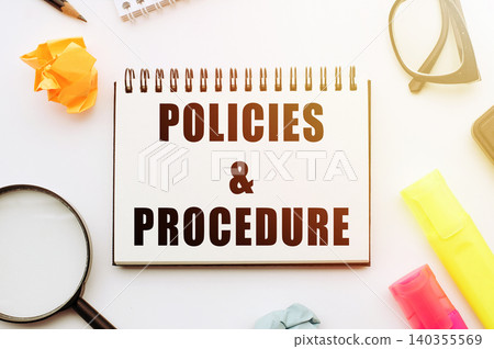 Text POLICIES and PROCEDURE in notebook on white table with office tools. 140355569