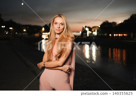 Evening elegance by the water under a twilight sky Evening elegance by the water under a twilight sky 140355625