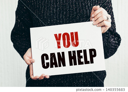 Girl holding a card with text you can help Girl holding a card with text you can help 140355683