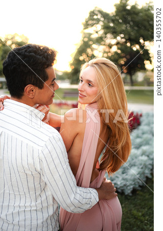 Couple enjoying a romantic moment during golden hour in the park Couple enjoying a romantic moment during golden hour in the park 140355702
