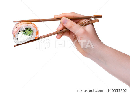 Isolated hand holding a single california uramaki roll with wooden chopsticks on white background jpeg Isolated hand holding a single california uramaki roll with wooden chopsticks on white background jpeg 140355802