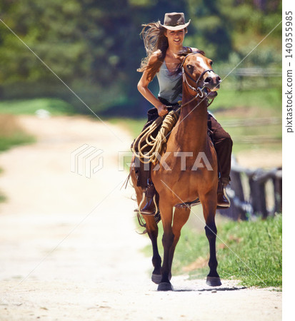 Happy woman, countryside and cowgirl with horse for ride, journey or outdoor adventure in nature. Female person or western rider with hat, saddle and animal stallion or riding pet at ranch or farm Happy woman, countryside and cowgirl with horse for ride, journey or outdoor adventure in nature. Female person or western rider with hat, saddle and animal stallion or riding pet at ranch or farm 140355985