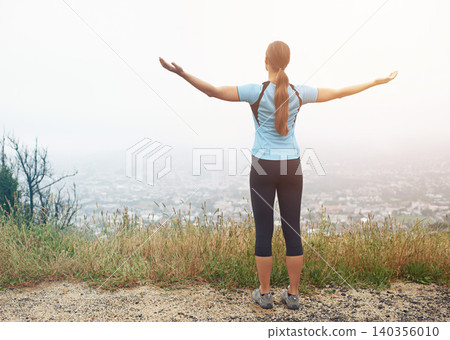 Exercise, freedom and sports with runner woman outdoor in mountains for cardio training or workout. Fitness, nature and view with athlete running in foggy morning for health or wellness from back 140356010