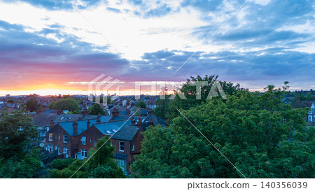 Orange sunset over London suburban townhouses with a railway line Orange sunset over London suburban townhouses with a railway line 140356039