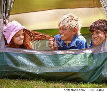 Kids, camp and outdoors for tent, friends and nature on summer vacation with boys pulling person hair. Children, annoyed girl and holiday for adventure, tease and camping in backyard and on grass Kids, camp and outdoors for tent, friends and nature on summer vacation with boys pulling person hair. Children, annoyed girl and holiday for adventure, tease and camping in backyard and on grass 140356061