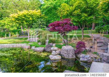 Scenic landscape view of Kyoto Garden in Holland Park, West London, during a sunny spring day. Scenic landscape view of Kyoto Garden in Holland Park, West London, during a sunny spring day. 140356087