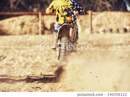 Person, motorcyclist and dust with dirt bike on track for race, extreme sports or outdoor competition. Rear view of expert rider on motorbike, scrambler or sand course for off road rally challenge Person, motorcyclist and dust with dirt bike on track for race, extreme sports or outdoor competition. Rear view of expert rider on motorbike, scrambler or sand course for off road rally challenge 140356122