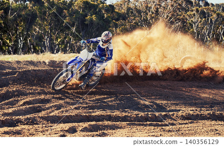Person, dirt bike and professional motorcyclist racing in extreme sports or competition on outdoor track. Expert rider on motorbike or scrambler for sand course, challenge or off road rally in nature 140356129