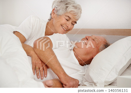 Senior couple, hug and communication in bed, relaxing and love in retirement for bonding on weekend. Happy elderly people, conversation and embracing in marriage, romance and morning routine at home Senior couple, hug and communication in bed, relaxing and love in retirement for bonding on weekend. Happy elderly people, conversation and embracing in marriage, romance and morning routine at home 140356131