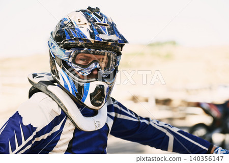 Motorbike, extreme sport and portrait for man in helmet for competition, race and games with safety. Person, motorcycle and outdoor for contest, motor cross and fast transport with speed in desert Motorbike, extreme sport and portrait for man in helmet for competition, race and games with safety. Person, motorcycle and outdoor for contest, motor cross and fast transport with speed in desert 140356147