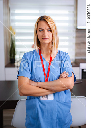 Serious doctor posing with arms crossed in clinic 140356228