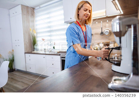 Nurse preparing coffee in the kitchen during a break 140356239