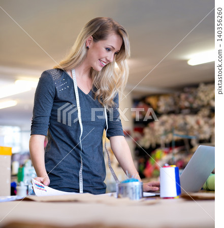 Business, woman and designer with laptop for fashion, fabric research or web design concept at work. Creative, person or happy tailor with technology for online pattern, inspiration or sewing textile Business, woman and designer with laptop for fashion, fabric research or web design concept at work. Creative, person or happy tailor with technology for online pattern, inspiration or sewing textile 140356260
