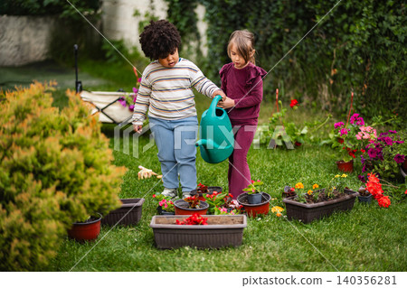 Children learning about gardening and planting flowers together 140356281
