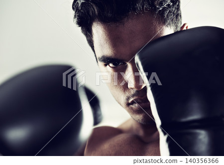 Portrait, man and boxer in training, exercise and workout for body health isolated on a grey studio background. Fight, serious face and athlete in gloves for fitness, sports and stance in Brazil Portrait, man and boxer in training, exercise and workout for body health isolated on a grey studio background. Fight, serious face and athlete in gloves for fitness, sports and stance in Brazil 140356366
