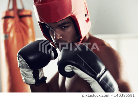 Sports, portrait and man boxer in gym for exercise, workout and combat training for competition. Breathing, health and shirtless male athlete fighter in boxing ring with gloves in fitness center. Sports, portrait and man boxer in gym for exercise, workout and combat training for competition. Breathing, health and shirtless male athlete fighter in boxing ring with gloves in fitness center. 140356591