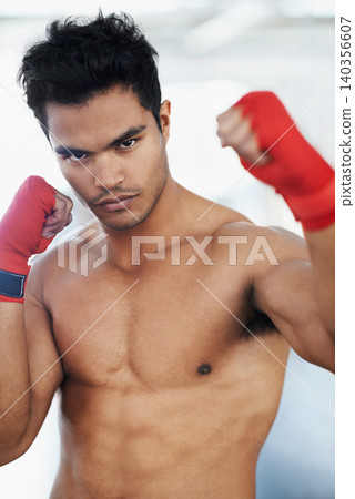 Portrait, man and boxer in club for sports, training and workout for healthy body. Fighter, face and serious athlete with muscle on abs for fitness, exercise and martial arts at a gym in Brazil Portrait, man and boxer in club for sports, training and workout for healthy body. Fighter, face and serious athlete with muscle on abs for fitness, exercise and martial arts at a gym in Brazil 140356607